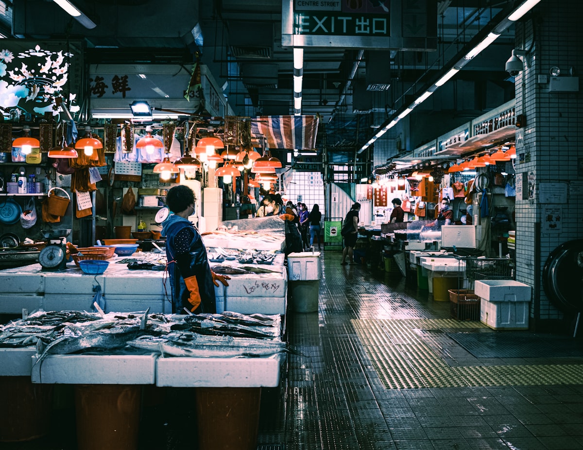 Stimmungsvolle Fischmarkthalle mit warmen Lampen über den Auslagen am frühen Morgen